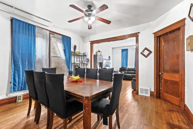 6821 S Campbell Ave, Chicago, IL 60629 - dining room featuring wood-type flooring, ceiling fan, and baseboards