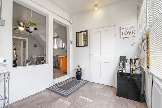 tiled foyer entrance featuring ceiling fan