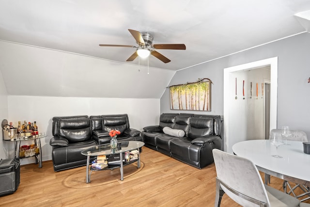 living room with lofted ceiling, light hardwood / wood-style flooring, and ceiling fan