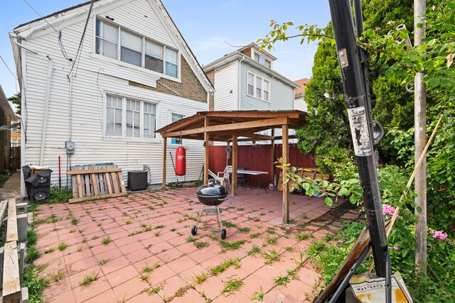 rear view of house featuring a patio and central AC