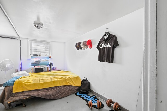 bedroom featuring concrete floors