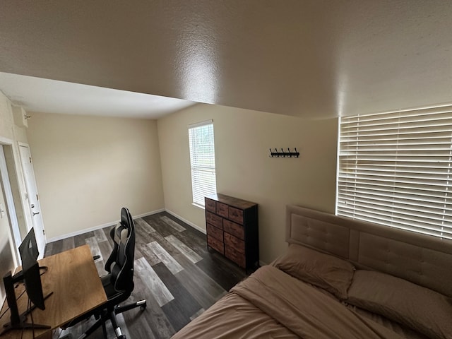 bedroom featuring dark wood-type flooring and vaulted ceiling