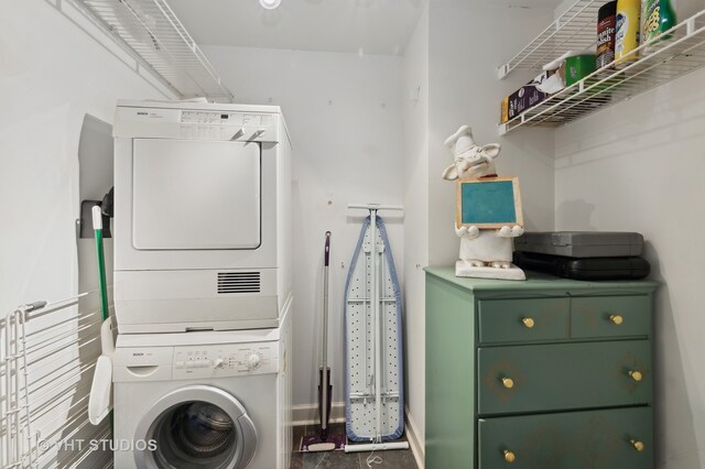 laundry room with stacked washer and clothes dryer