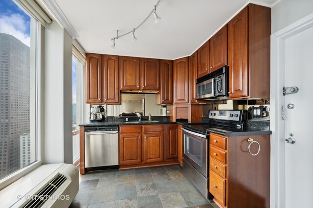 kitchen with tile patterned floors, sink, stainless steel appliances, and rail lighting