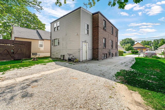 back of house with a lawn