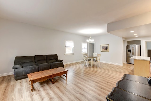 living room featuring a notable chandelier and hardwood / wood-style floors