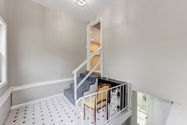 stairway featuring light tile patterned flooring