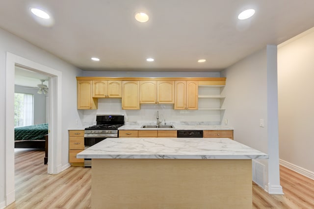 kitchen featuring stainless steel range with gas cooktop, light brown cabinetry, light hardwood / wood-style flooring, and sink