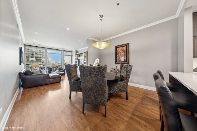 dining room featuring hardwood / wood-style floors, ornamental molding, and floor to ceiling windows