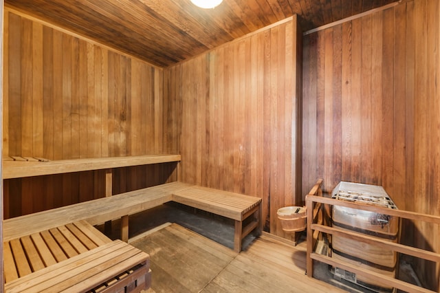 view of sauna with wooden ceiling, wood-type flooring, and wood walls