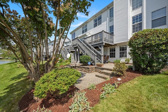 view of home's community featuring a patio area, a yard, and a deck