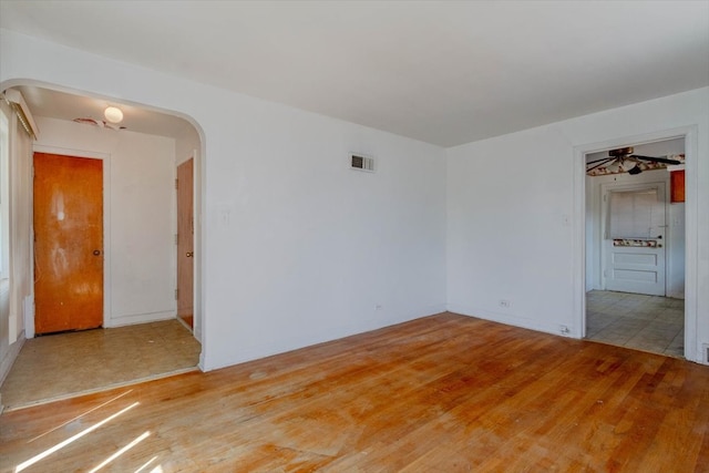 spare room with light wood-type flooring and ceiling fan