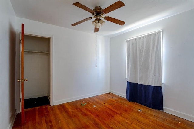 unfurnished bedroom featuring hardwood / wood-style flooring, a closet, and ceiling fan