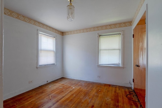 unfurnished room with hardwood / wood-style floors