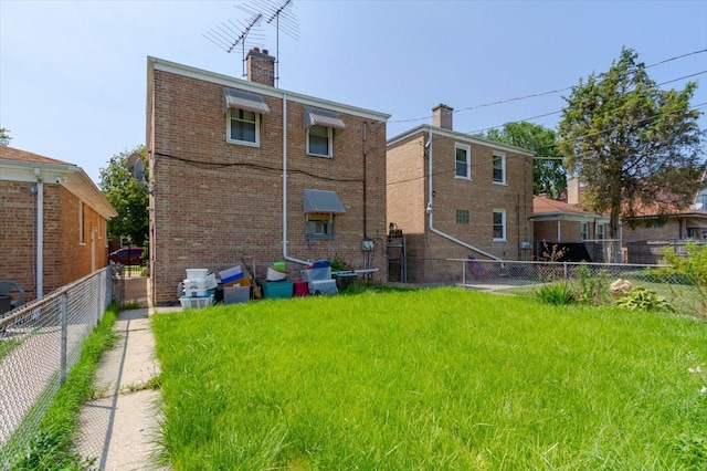 back of house with a lawn