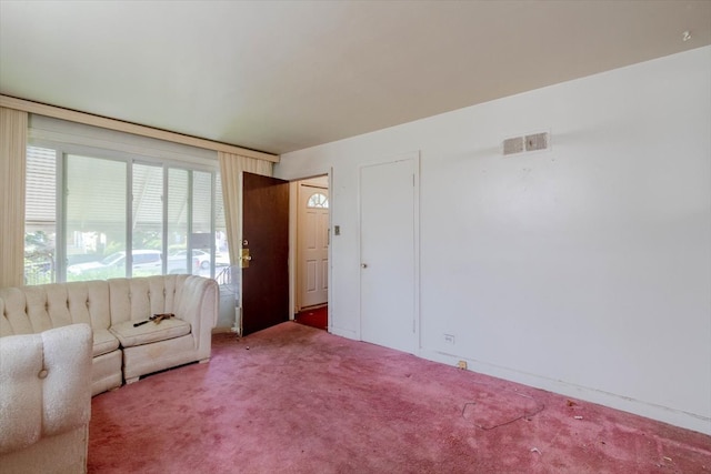 unfurnished living room featuring carpet