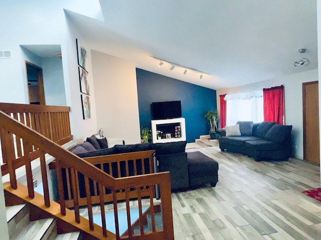 living room with track lighting and light hardwood / wood-style floors