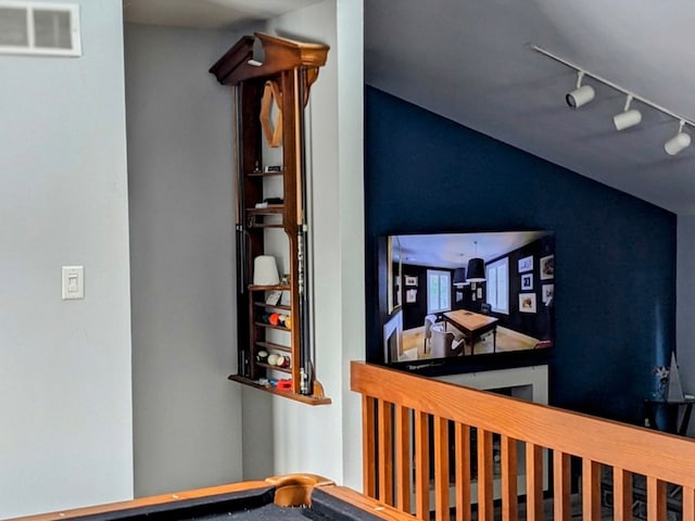 staircase featuring rail lighting