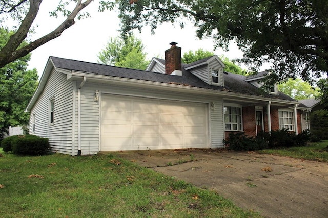 view of property exterior featuring a garage and a lawn