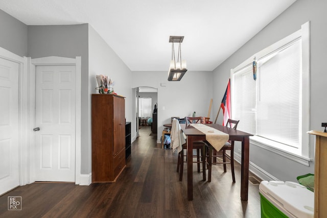 dining space with dark wood-type flooring