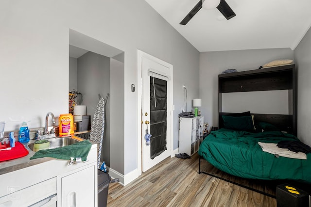 bedroom with sink, ceiling fan, and light hardwood / wood-style flooring