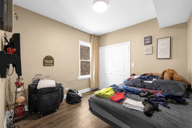 bedroom featuring dark hardwood / wood-style floors and a closet