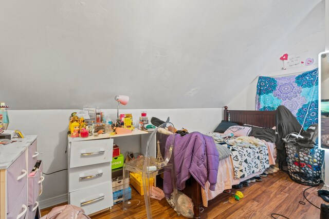 bedroom featuring wood-type flooring and lofted ceiling