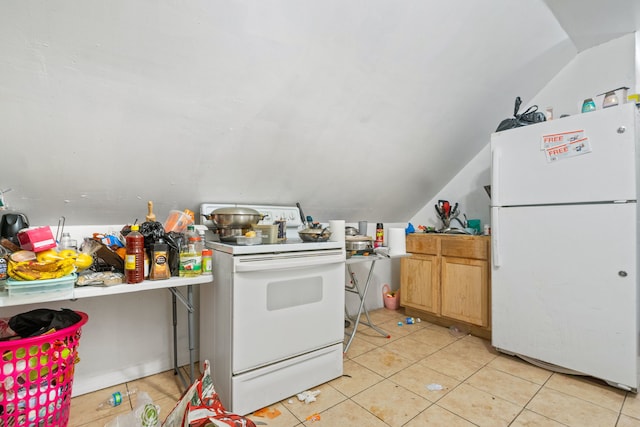 kitchen with light tile patterned floors, vaulted ceiling, and white appliances