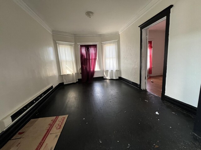 unfurnished room with wood-type flooring and ornamental molding