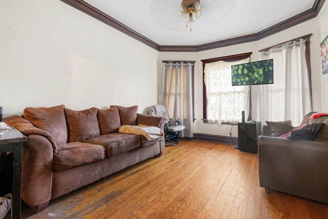 living room with ceiling fan, hardwood / wood-style flooring, and ornamental molding