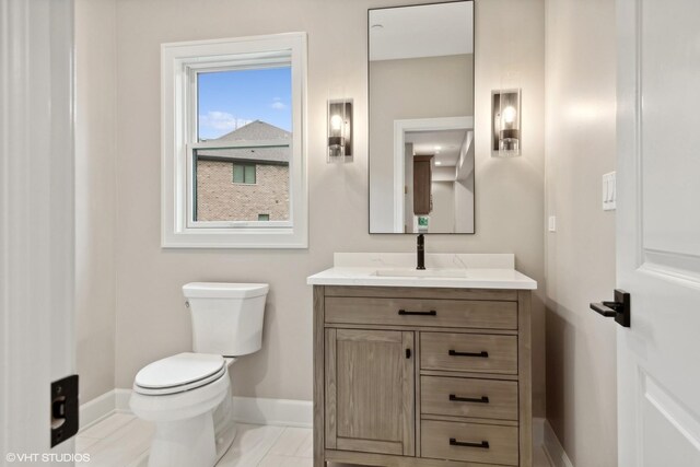 bathroom featuring tile patterned floors, vanity, and toilet