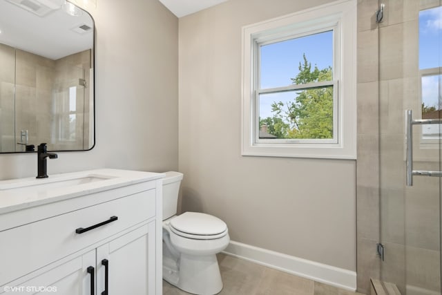 bathroom with vanity, walk in shower, and toilet