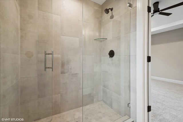 bathroom featuring an enclosed shower and ceiling fan