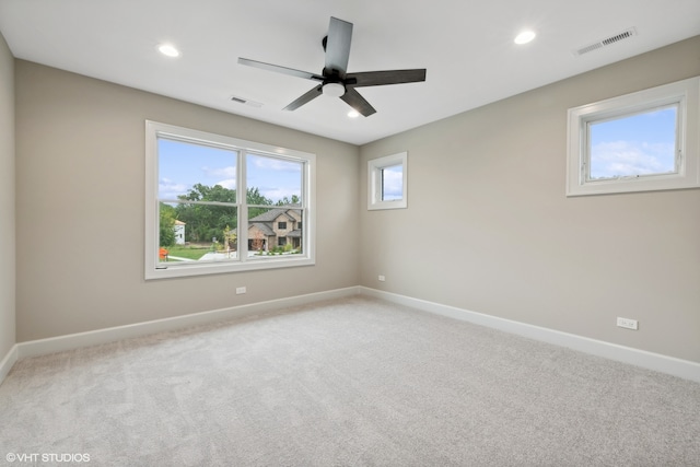 unfurnished room with light carpet and ceiling fan