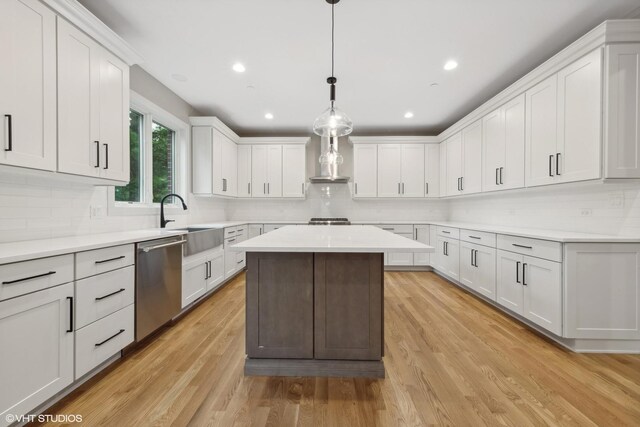 kitchen featuring dishwasher, tasteful backsplash, and light wood-type flooring