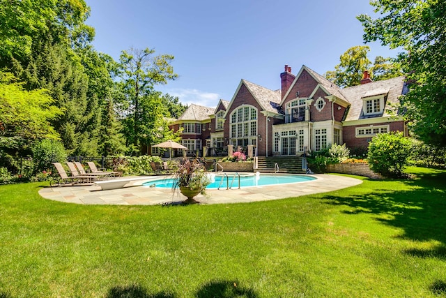 rear view of property featuring a patio and a yard