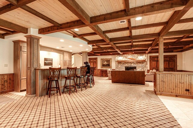 546 Lakeland Dr, Lake Bluff, IL 60044 - indoor bar with decorative columns, beam ceiling, wainscoting, a stone fireplace, and coffered ceiling