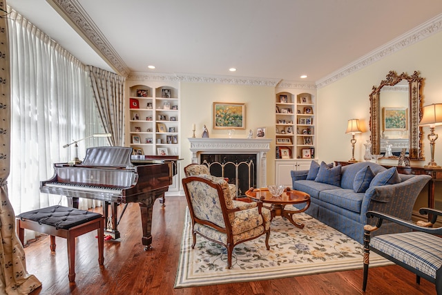 living room featuring built in features, wood-type flooring, and crown molding