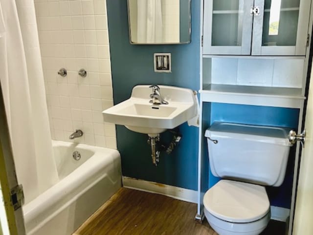 bathroom featuring shower / bath combo with shower curtain, toilet, and hardwood / wood-style flooring