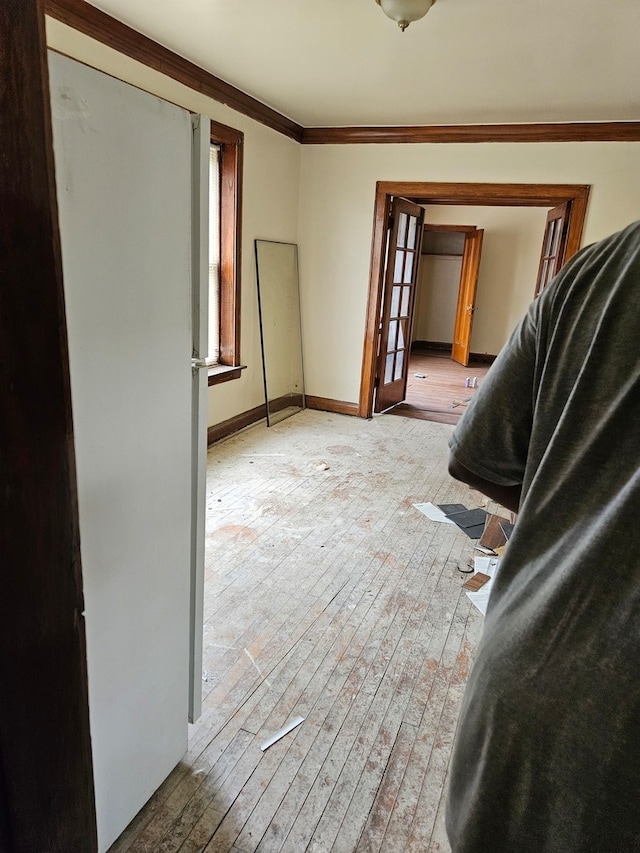 interior space featuring light hardwood / wood-style floors and crown molding