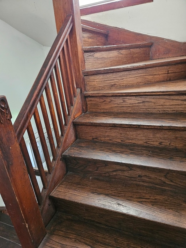 staircase with hardwood / wood-style flooring