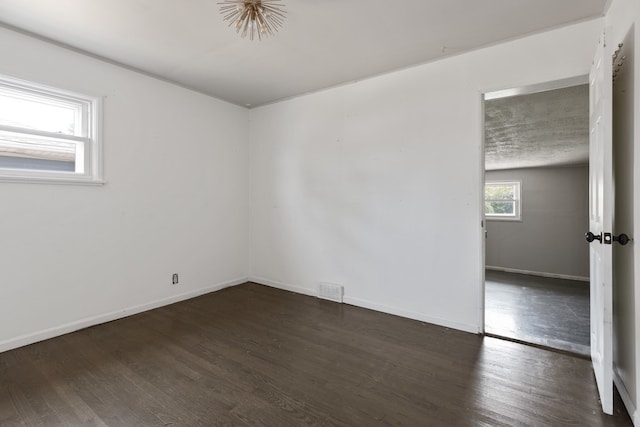 spare room featuring dark hardwood / wood-style floors