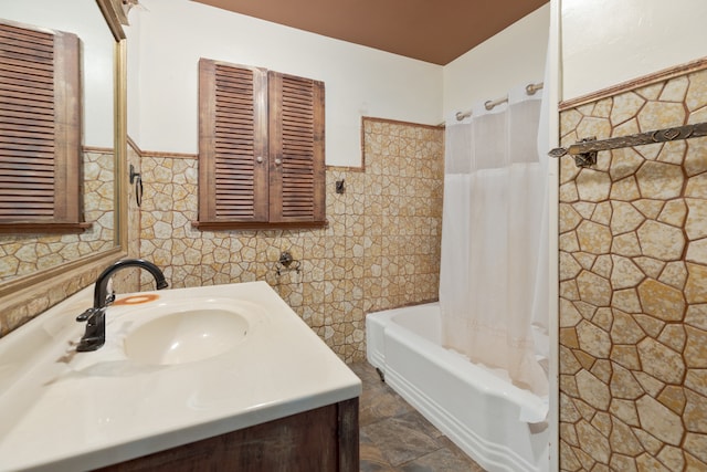 bathroom with vanity, tile walls, and shower / tub combo