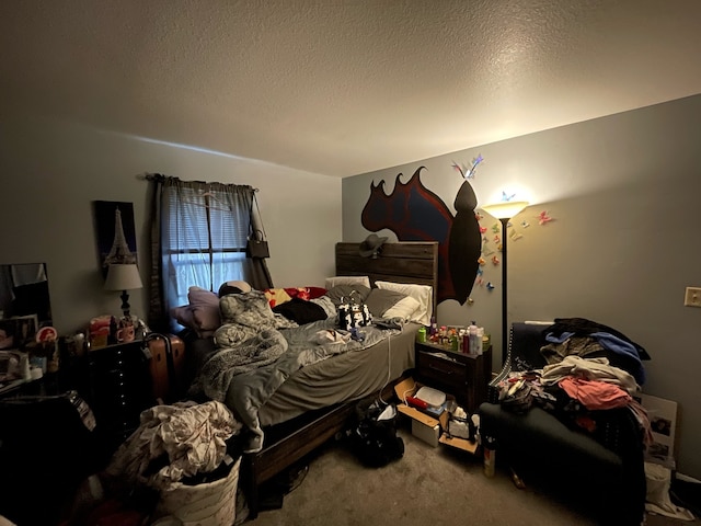 bedroom with a textured ceiling and carpet flooring