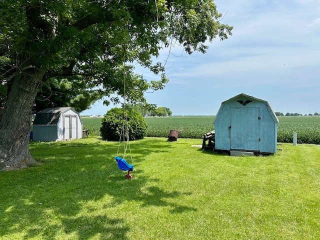 view of yard featuring a storage unit and a rural view