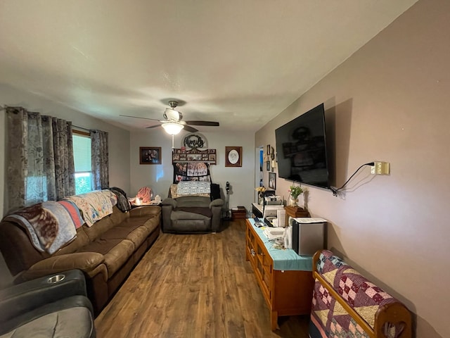 living room featuring wood-type flooring and ceiling fan