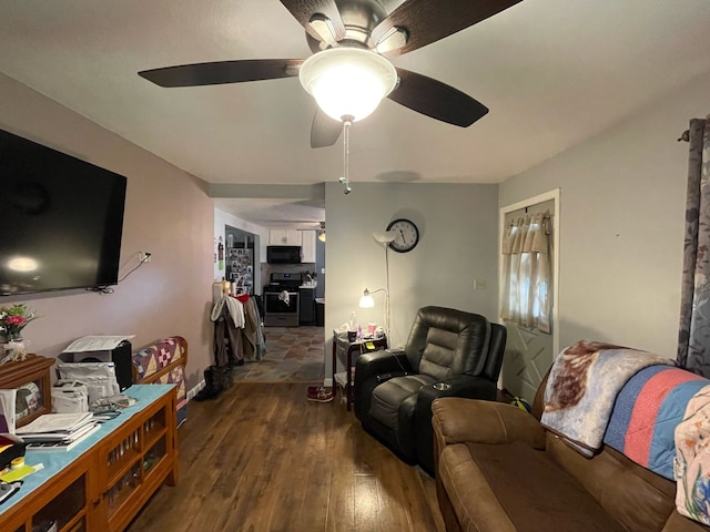 living room featuring dark hardwood / wood-style flooring and ceiling fan