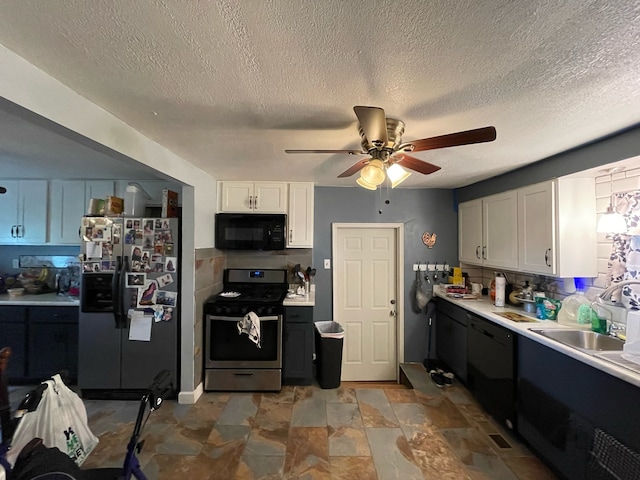 kitchen with white cabinetry, ceiling fan, tile patterned floors, black appliances, and sink