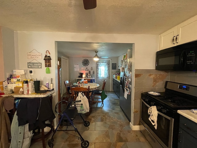 kitchen featuring stainless steel range with gas stovetop, refrigerator with ice dispenser, a textured ceiling, and ceiling fan