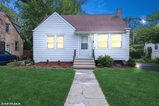 bungalow-style home with a front lawn